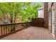 Deck with wooden flooring and railing featuring a view of the lush surrounding greenery at 2301 Waters Edge Trl, Roswell, GA 30075