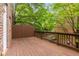 Deck with wooden flooring and railing featuring a view of the lush surrounding greenery at 2301 Waters Edge Trl, Roswell, GA 30075