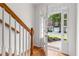 Bright entryway with hardwood floors, stairs, and front door view to exterior at 2301 Waters Edge Trl, Roswell, GA 30075