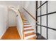 Bright entryway with hardwood floors, stairs, and black-framed glass door at 2301 Waters Edge Trl, Roswell, GA 30075