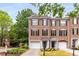 Charming brick townhome with black shutters, manicured lawn, and attached one car garage at 2301 Waters Edge Trl, Roswell, GA 30075