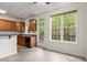 Kitchen includes stainless steel appliances, wooden cabinets, eat-in bar, and natural light at 2301 Waters Edge Trl, Roswell, GA 30075