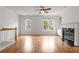 Living area features hardwood floors, a fireplace, and plenty of natural light from the large windows at 2301 Waters Edge Trl, Roswell, GA 30075