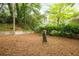 Private backyard with mature trees, and a retaining wall at 3007 Stratford Arms Dr, Chamblee, GA 30341