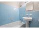 Bathroom featuring a tub and shower combination with blue tiling and a pedestal sink at 3007 Stratford Arms Dr, Chamblee, GA 30341