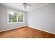 Cozy bedroom featuring wood floors, white trim and large window with backyard views at 3007 Stratford Arms Dr, Chamblee, GA 30341