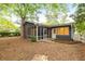 Cozy home featuring a screened porch, brick chimney and a fenced yard at 3007 Stratford Arms Dr, Chamblee, GA 30341