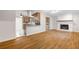Open floor plan showcasing hardwood floors, a brick fireplace, and seamless kitchen access at 3007 Stratford Arms Dr, Chamblee, GA 30341