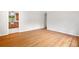 Bright living room featuring hardwood floors, neutral walls, an open doorway to another room and a window at 3007 Stratford Arms Dr, Chamblee, GA 30341