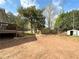 Spacious backyard with trees, a shed, and a deck on the back of the house at 326 Old Farm Road, Woodstock, GA 30188