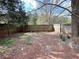 Backyard with wooden fence and mature tree at 326 Old Farm Road, Woodstock, GA 30188