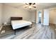 A minimalist bedroom with gray vinyl flooring, a ceiling fan, and neutral-toned walls at 326 Old Farm Road, Woodstock, GA 30188