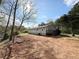 Exterior view of home with a long driveway and yard at 326 Old Farm Road, Woodstock, GA 30188