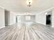 Large open-plan living area featuring gray vinyl floors and fresh paint; perfect for entertaining at 326 Old Farm Road, Woodstock, GA 30188