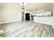 A bright, open-concept kitchen and dining area, with sleek gray vinyl floors and updated appliances at 326 Old Farm Road, Woodstock, GA 30188