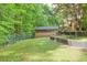 Spacious backyard featuring a manicured lawn, trees and an outbuilding at 3493 Wood Acres Blvd, Duluth, GA 30096