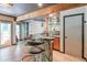 Home bar area featuring a stone-base counter, seating, and built-in shelving for displaying glassware and spirits at 3493 Wood Acres Blvd, Duluth, GA 30096