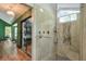 Modern bathroom features a glass-enclosed shower with stylish fixtures, next to a closet or bedroom space at 3493 Wood Acres Blvd, Duluth, GA 30096