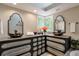 Elegant bathroom featuring dual vessel sinks, custom cabinetry, and modern mirrors at 3493 Wood Acres Blvd, Duluth, GA 30096