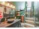 Rustic bathroom with a stone-walled shower, wood-style vanity, and nature-inspired decor creating a unique spa experience at 3493 Wood Acres Blvd, Duluth, GA 30096