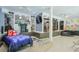 Unique basement bedroom with built-in shelving, a spiral staircase, and gaming decor for a playful vibe at 3493 Wood Acres Blvd, Duluth, GA 30096