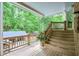 View of the deck with stairs, railing and outdoor furniture overlooking a beautiful treed backyard at 3493 Wood Acres Blvd, Duluth, GA 30096