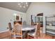 This dining room features hardwood floors and a table set for six beneath a modern chandelier at 3493 Wood Acres Blvd, Duluth, GA 30096