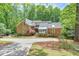 Charming brick home with lush landscaping, a circular driveway, and mature trees at 3493 Wood Acres Blvd, Duluth, GA 30096