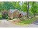 Brick home featuring well-maintained landscaping, a stone accent wall and ample parking at 3493 Wood Acres Blvd, Duluth, GA 30096