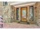 Brick entryway with stone accents and a decorative front door at 3493 Wood Acres Blvd, Duluth, GA 30096