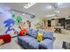 Finished basement with foosball table, playful cartoon murals, and comfortable seating at 3493 Wood Acres Blvd, Duluth, GA 30096