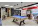 Spacious basement game room with a pool table, game machines, and lounge area at 3493 Wood Acres Blvd, Duluth, GA 30096