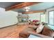 Comfortable living room with a stone fireplace and lots of natural light from the large windows and door at 3493 Wood Acres Blvd, Duluth, GA 30096