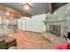 Open-concept living room with fireplace, wood-look floors, bar, and ample space for entertaining at 3493 Wood Acres Blvd, Duluth, GA 30096