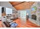 Open living room featuring a vaulted wood ceiling and stone fireplace at 3493 Wood Acres Blvd, Duluth, GA 30096