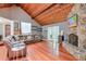 Spacious living room featuring a stone fireplace, wood floors, and vaulted wood ceilings at 3493 Wood Acres Blvd, Duluth, GA 30096