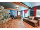 Living room featuring hardwood floors, a stone fireplace, and large windows at 3493 Wood Acres Blvd, Duluth, GA 30096