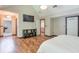 Large primary bedroom featuring a TV, shelving, and access to an en-suite bathroom at 3493 Wood Acres Blvd, Duluth, GA 30096
