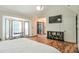 Large primary bedroom featuring a TV, shelving, and a set of bright bay windows at 3493 Wood Acres Blvd, Duluth, GA 30096