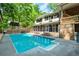 Beautiful in-ground pool with attached spa and screened-in porch on a sunny day at 3493 Wood Acres Blvd, Duluth, GA 30096