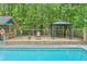 Relaxing gazebo and pool house with in-ground pool, ideal for summer fun at 3493 Wood Acres Blvd, Duluth, GA 30096