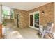 Relaxing covered porch with brickwork and view to the outside, a tranquil retreat at 3493 Wood Acres Blvd, Duluth, GA 30096