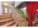 Unique stairway with decorative stone accents and lush greenery, leading to a stylish bar area and front entry at 3493 Wood Acres Blvd, Duluth, GA 30096