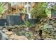 Picturesque koi pond with rock features and decorative mural adding charm at 3493 Wood Acres Blvd, Duluth, GA 30096