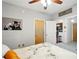 View into kitchen from cozy bedroom with neutral walls, decorative art, and soft lighting from ceiling fan at 898 Oak Sw St # 3207, Atlanta, GA 30310