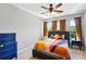 Bedroom with colorful bedspread, dark headboard, blue dresser and hardwood floors at 898 Oak Sw St # 3207, Atlanta, GA 30310