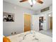 View into kitchen from cozy bedroom with neutral walls, decorative art, and soft lighting from ceiling fan at 898 Oak Sw St # 3207, Atlanta, GA 30310