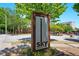 Sky Lofts brick and metal sign with colorful plants in the foreground of a landscaped community at 898 Oak Sw St # 3207, Atlanta, GA 30310