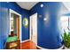 Hallway featuring blue walls, hardwood floors, and doorways leading to other rooms at 898 Oak Sw St # 3207, Atlanta, GA 30310