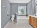 Bright bathroom featuring a soaking tub, large window, and vanity at 1220 Skipping Rock Sw Ln, Grayson, GA 30017